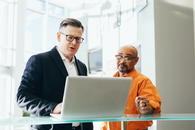 Two people looking at computer screen