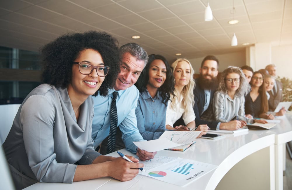 Diverse business team in a professional meeting at a modern office conference table.