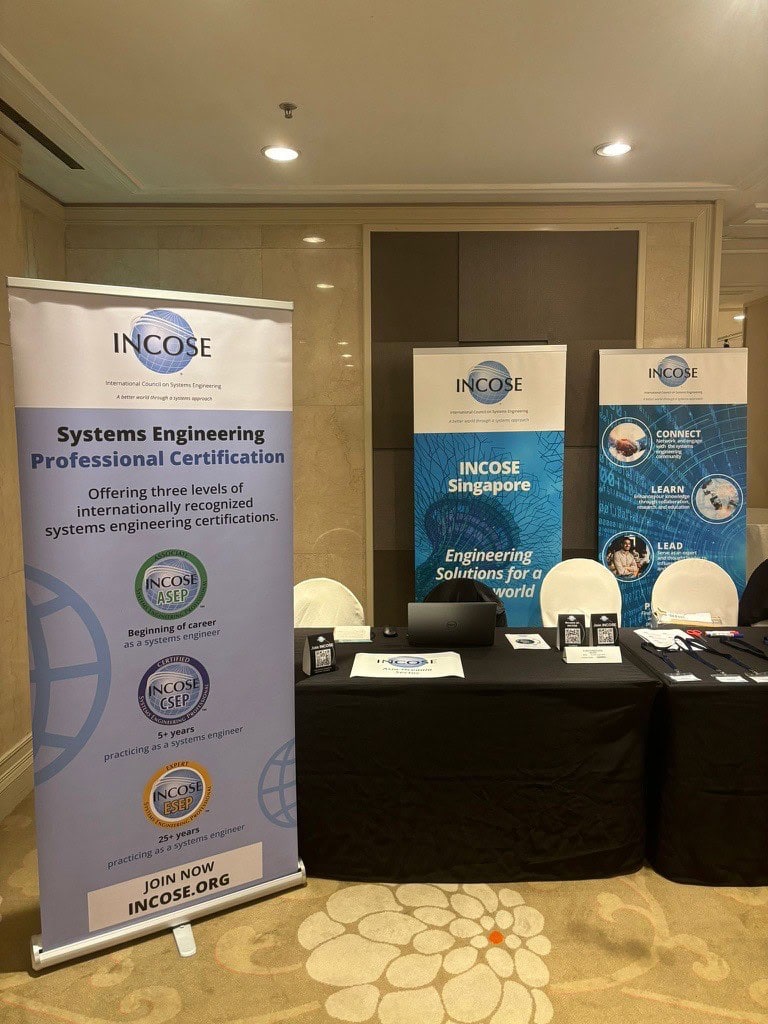 INCOSE Systems Engineering Certification booth at engineering conference.