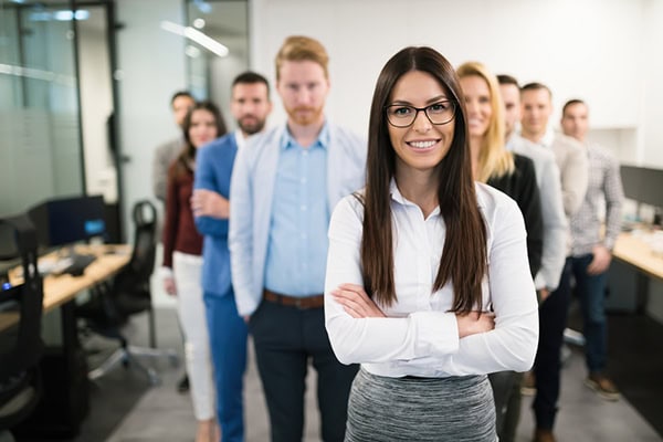Diverse professional team smiling in a modern office setting.