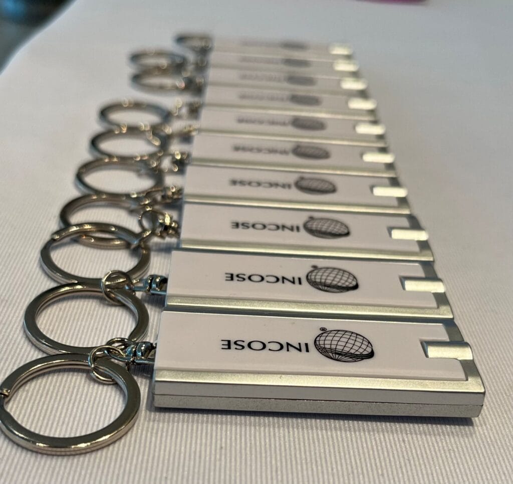 Innovative INCOSE branded metal keychains for professional networking and branding.