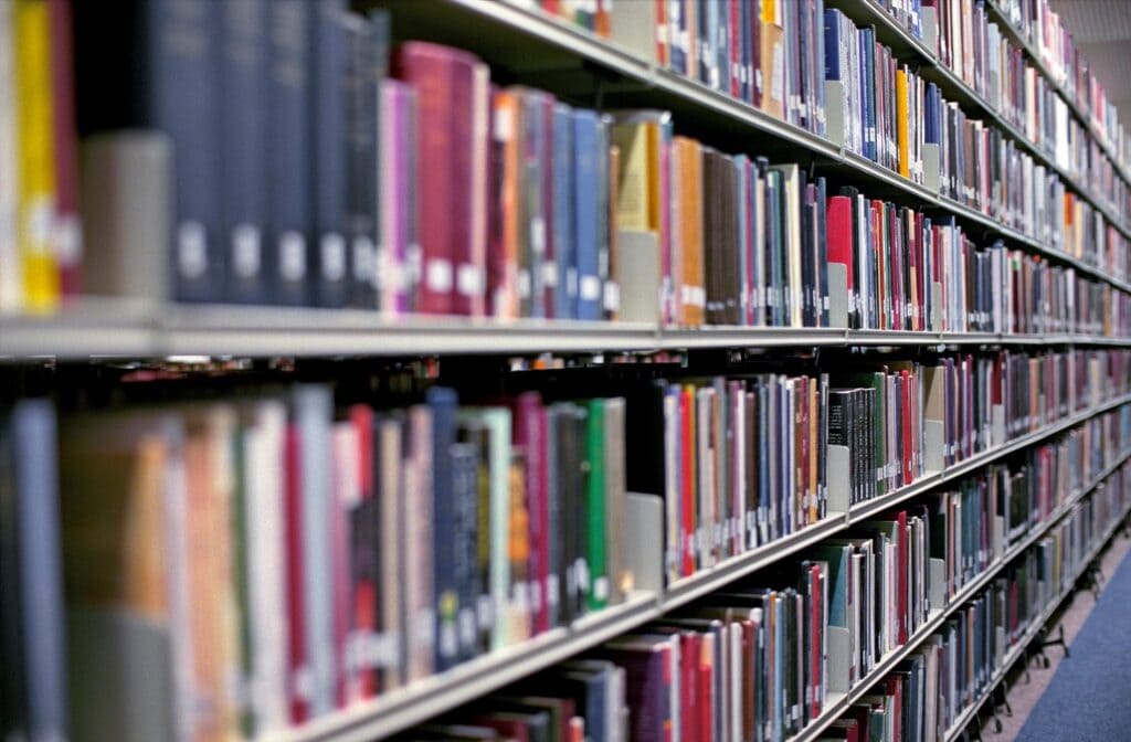 Library shelves filled with colorful books in a public library.