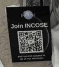 Detailed conference registration booth with event information and QR code for INCOSE access.