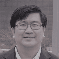 Experienced INCOSE member smiling outdoors in business attire.