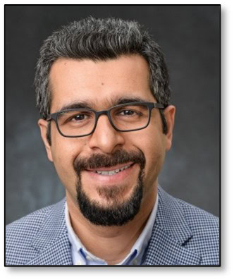 Expert professional smiling man with glasses in business attire, headshot.