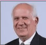 Innovative systems engineering conference speaker with a friendly smile.