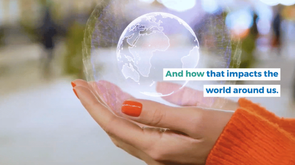 A person holding a transparent globe with a world map projections on it.